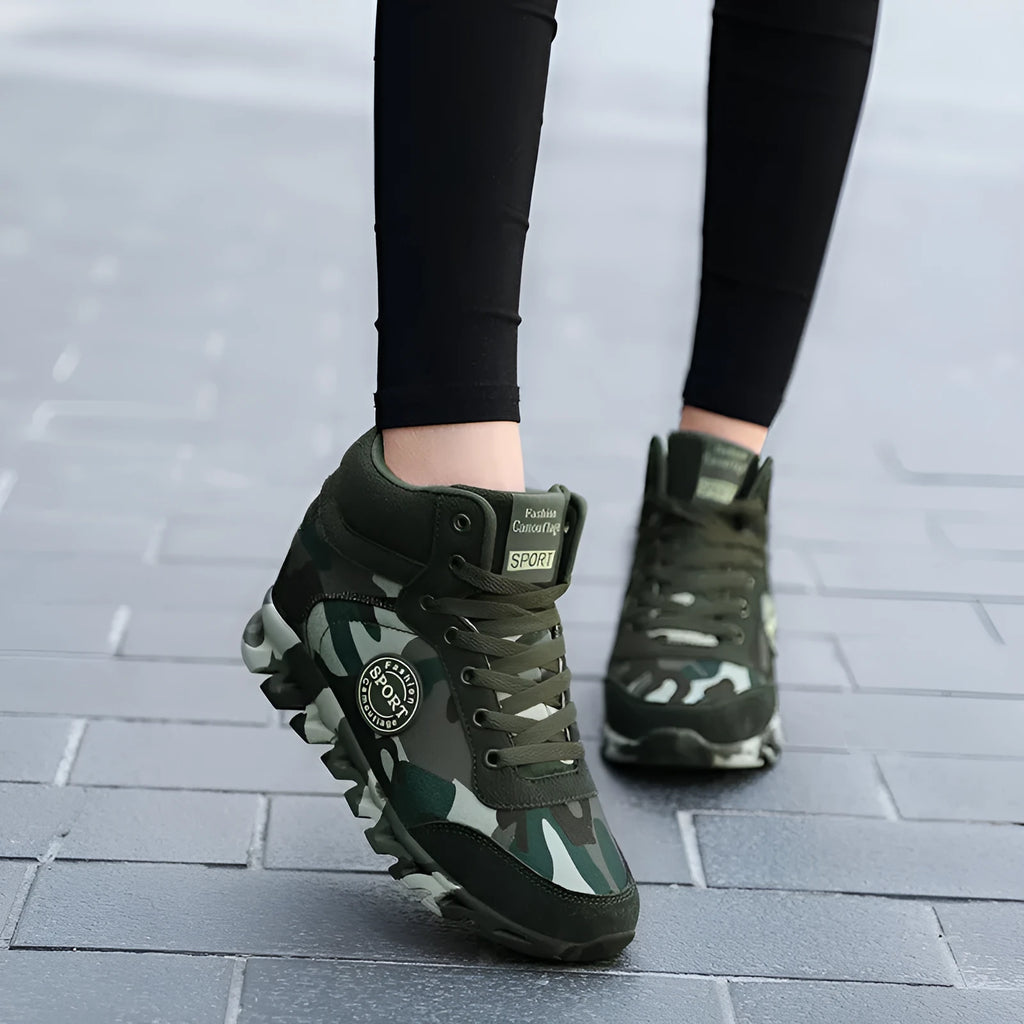 Green camouflage canvas women's sneakers with a rubber outsole on a white background.