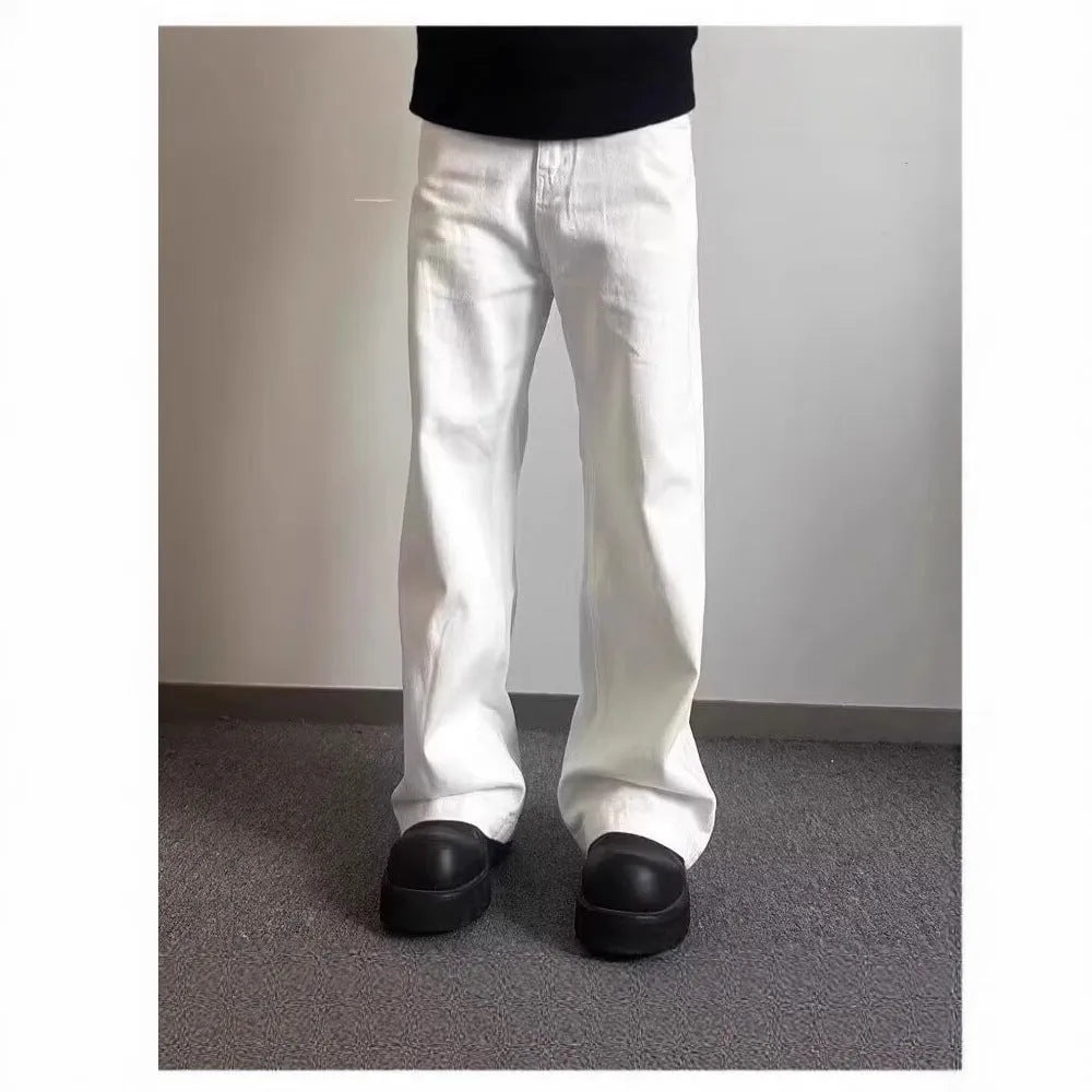 Men's white straight-leg denim jeans with a wide leg opening and a zip fly.