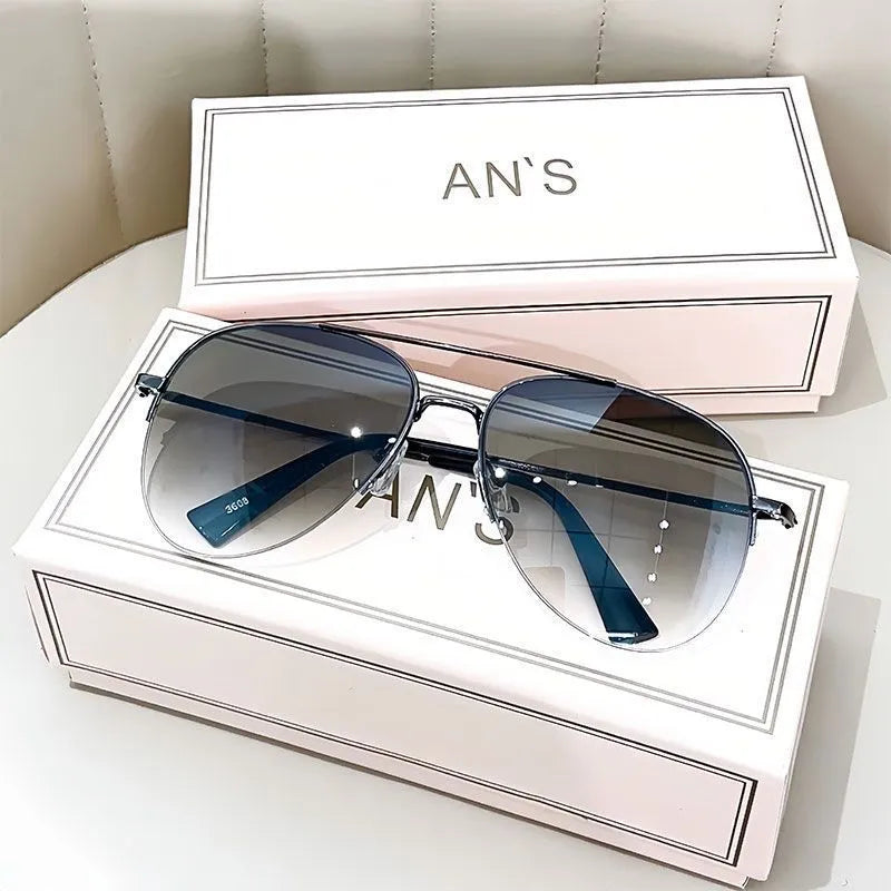 Gold frame aviator-style metal driving sunglasses with resin lenses for UV protection.