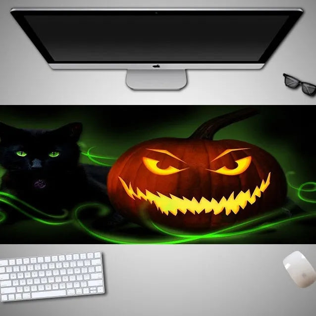 Oversized Halloween pattern mouse pad on a desk showing non-slip rubber base and cloth top.