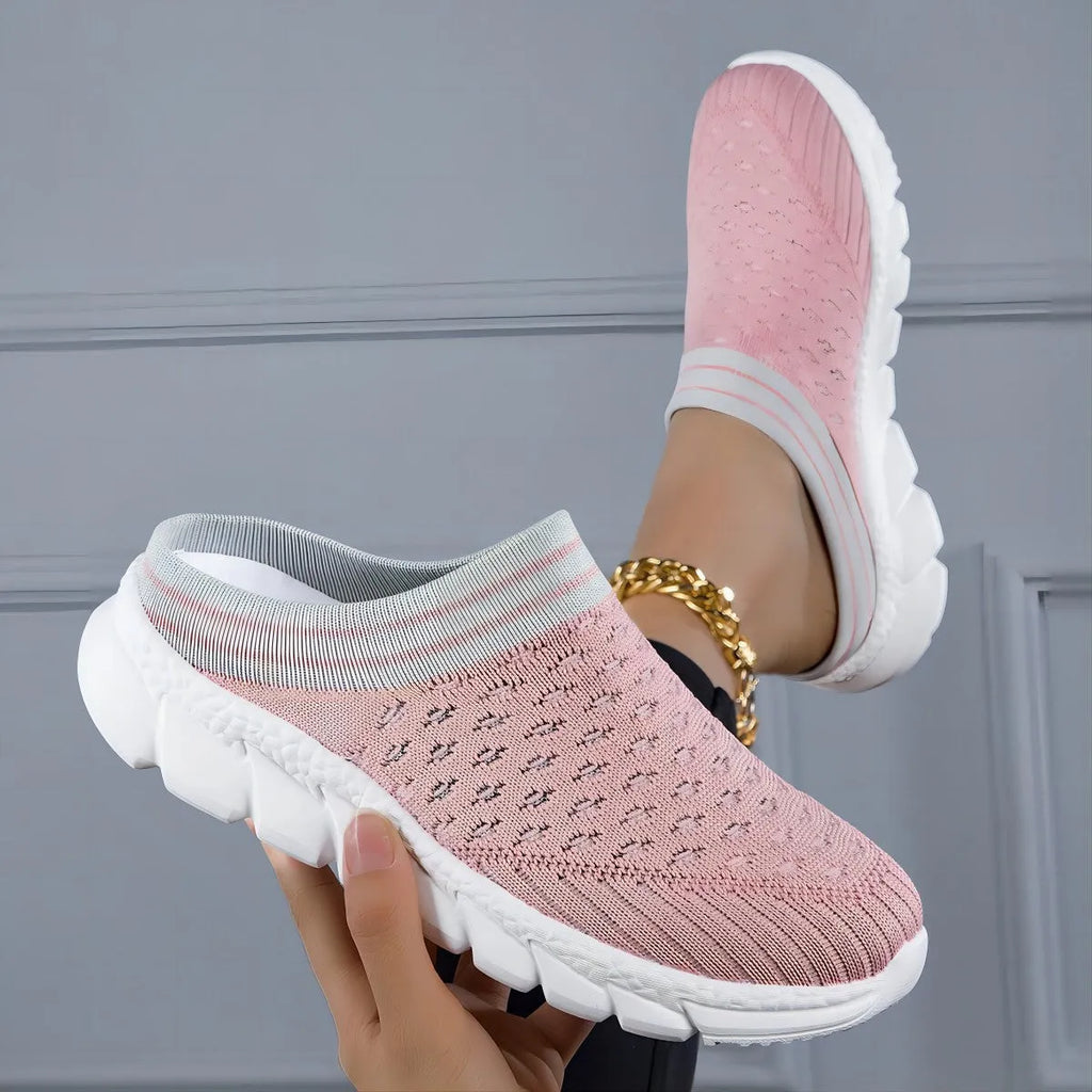 Women's black flyknit slippers with hollowed-out pattern and a height-increasing viscose sole.