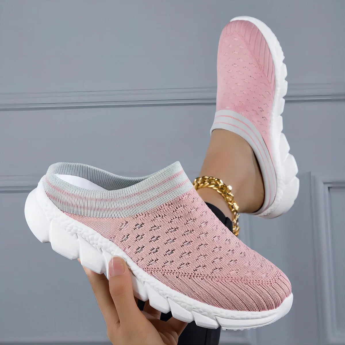 Women's black flyknit slippers with hollowed-out pattern and a height-increasing viscose sole.