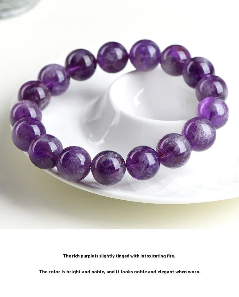 Natural feather amethyst crystal bracelet with geometric scattered beads and Ruyi design on a wrist.