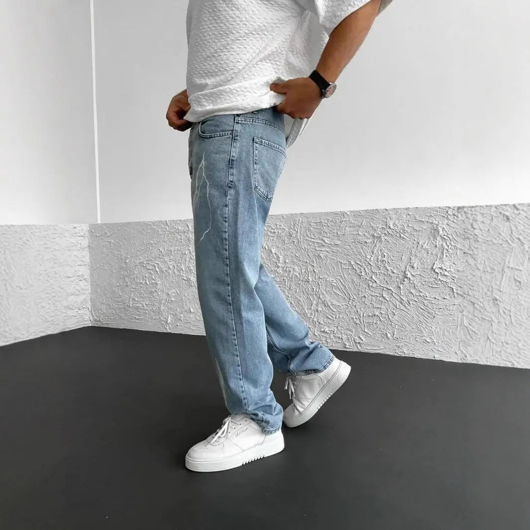 Blue men's straight-leg denim jeans with mid-waist fit and zipper fly displayed flat