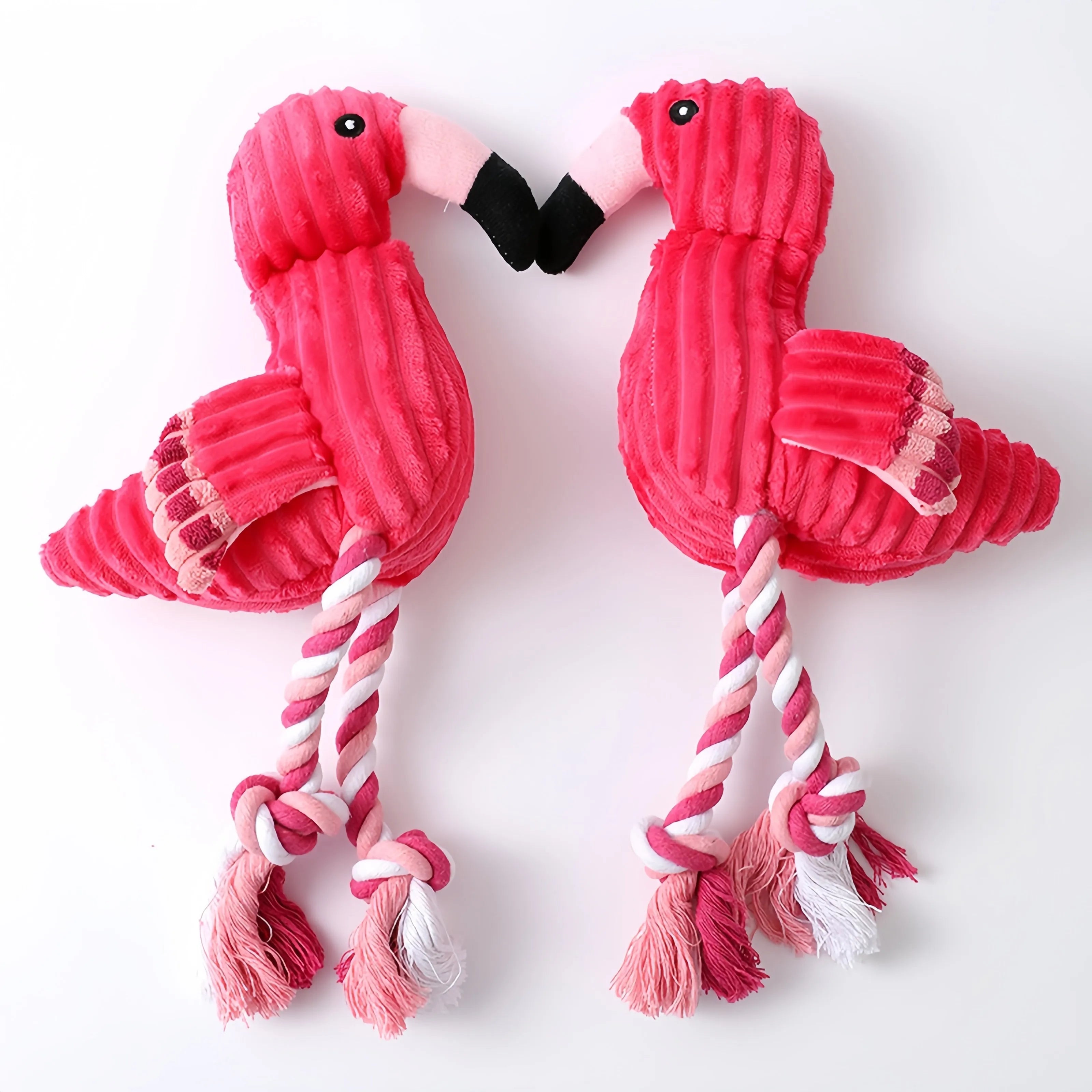 Pink animal-shaped corduroy plush dog toy with squeaker on a white background
