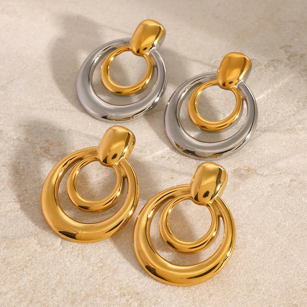 Gold plated double layer hollow stud earrings with round geometric design and titanium steel construction