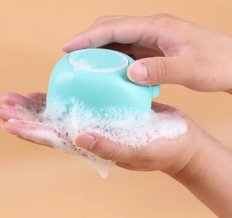 Blue silicone dog bath brush fitting over fingers for pet washing and massage