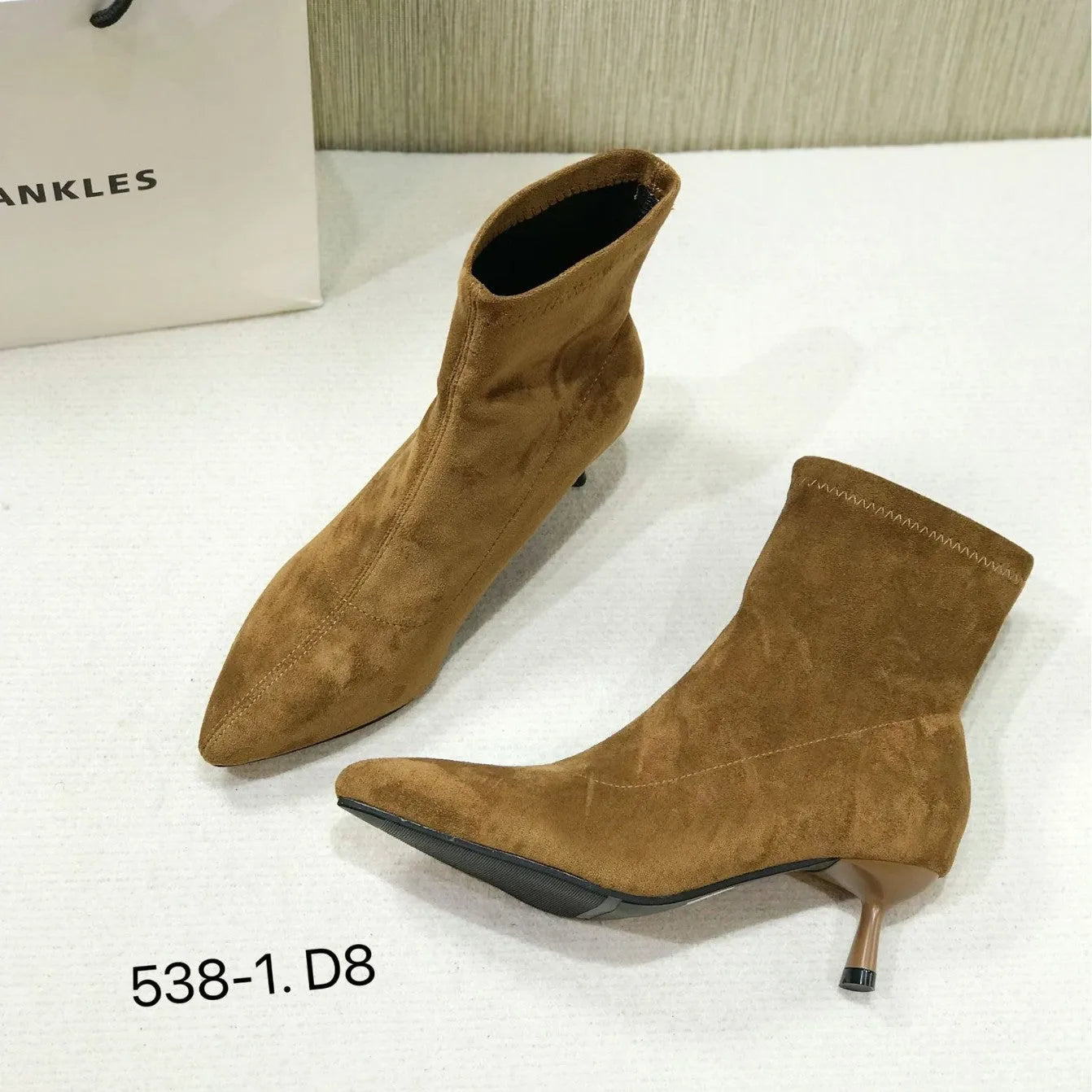 Women's black pointed toe ankle boots with stiletto heel and mid-calf length
