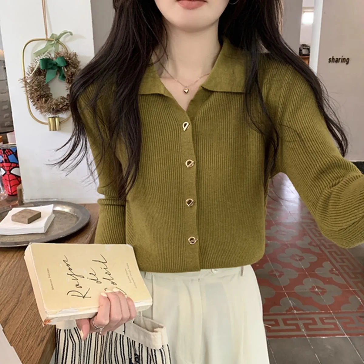 Loose fit beige viscose knitted cardigan top with long sleeves on a hanger