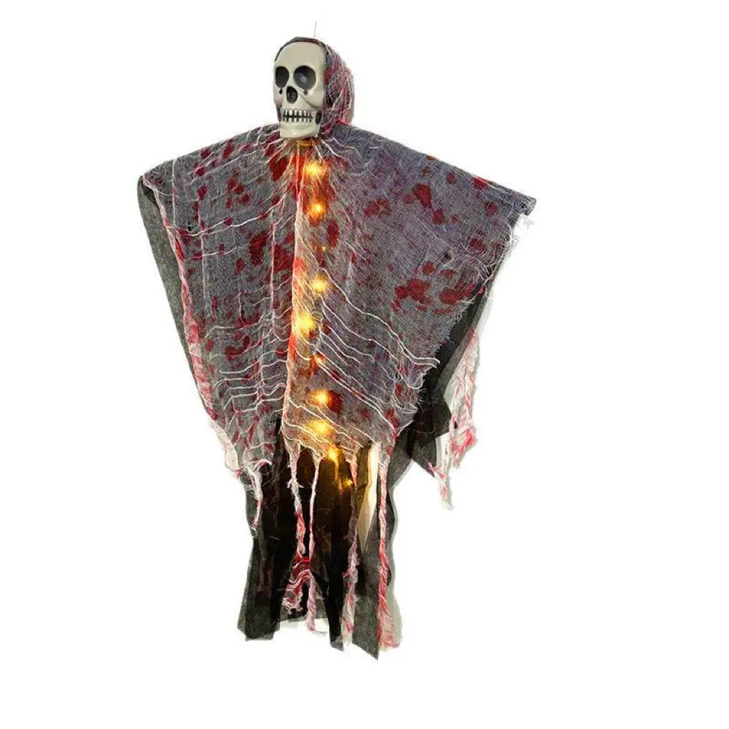 Halloween decoration showing a luminous blood-dyed plastic skull with a hanging ghost outdoor ornament