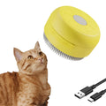 Green and yellow rechargeable cat dog steam brush with silicone head on a white background.
