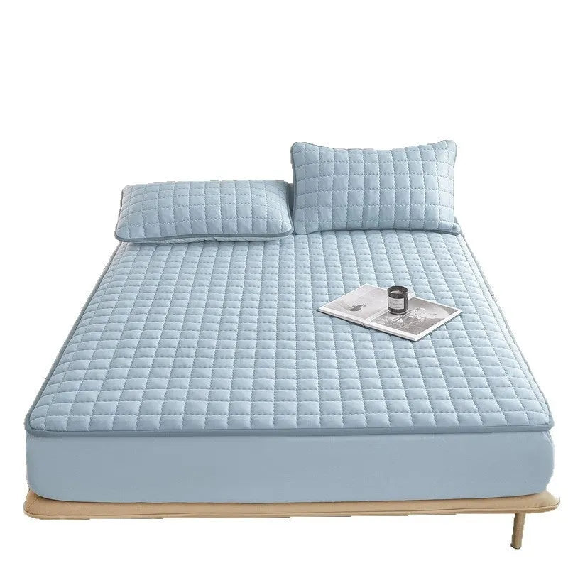 Blue washed cotton waterproof fitted sheet with elasticated corners on a mattress.