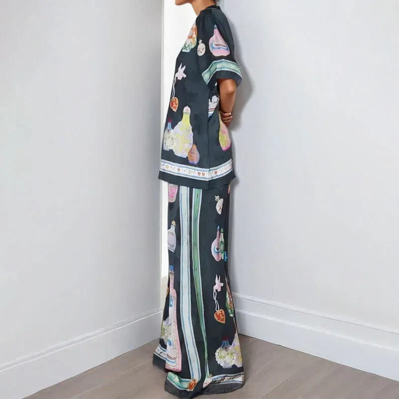 Women's black polyester co-ord set with cartoon animation print showing cardigan and trousers