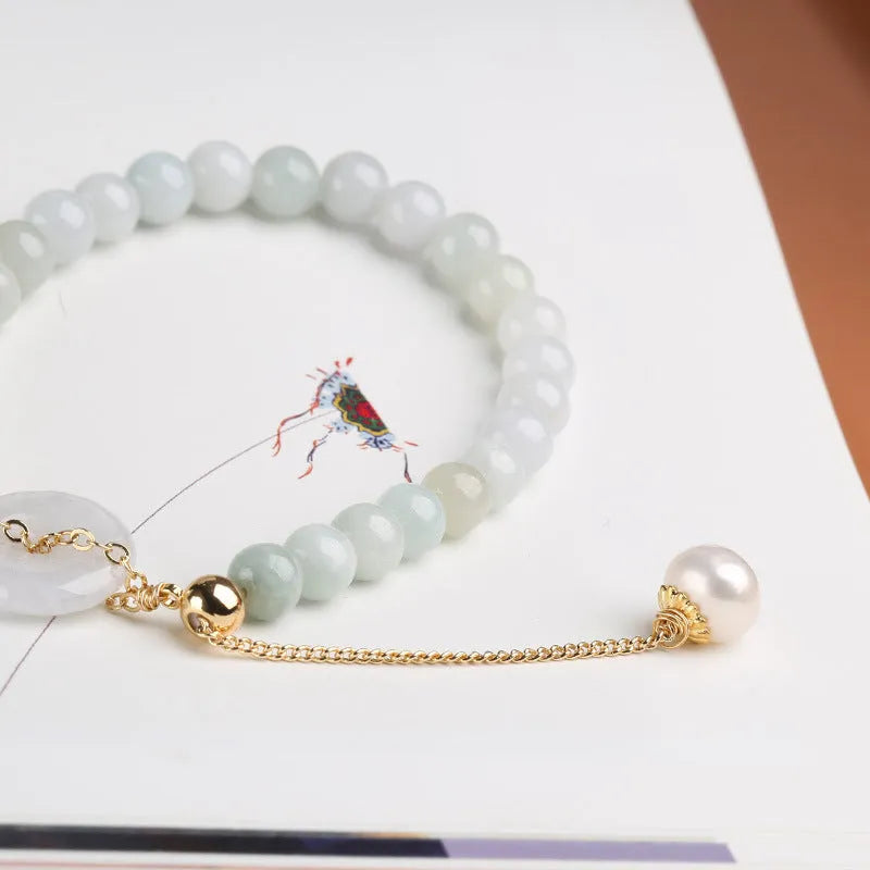 Natural emerald jade bracelet with pearl elements and peace buckle charm on adjustable cord