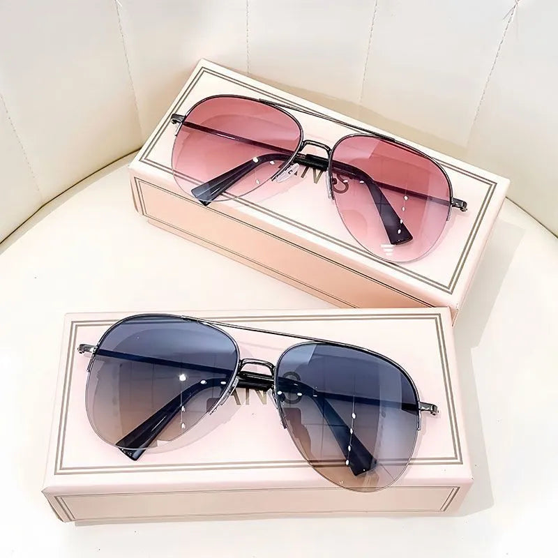 Gold frame aviator-style metal driving sunglasses with resin lenses for UV protection.