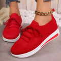 Women's black fly-knit casual sneakers with lace-up front and low-top design on a white background.