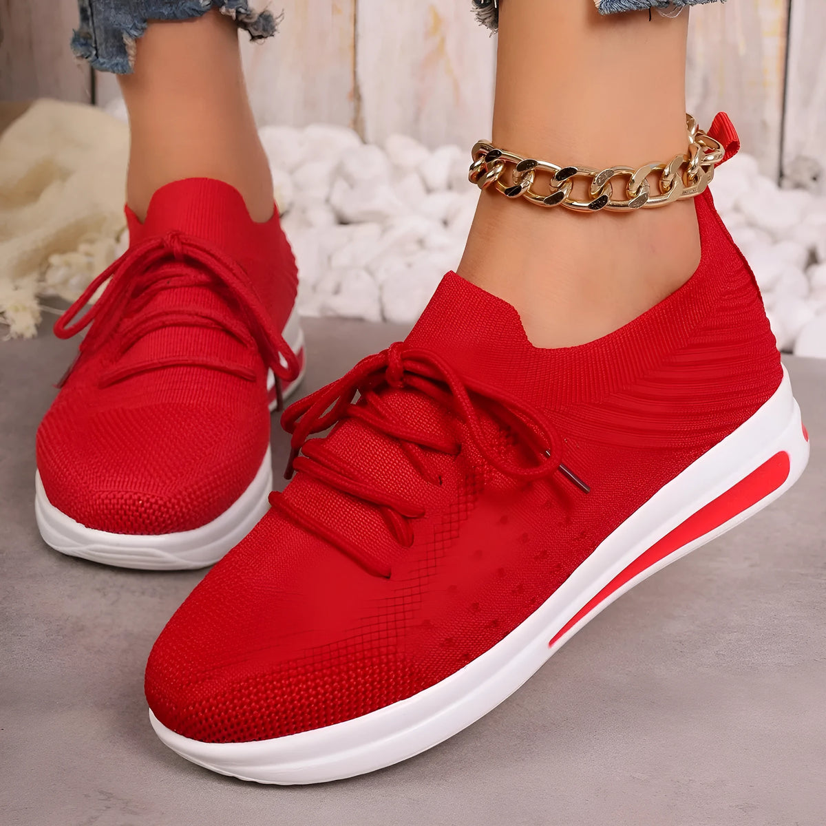 Women's black fly-knit casual sneakers with lace-up front and low-top design on a white background.