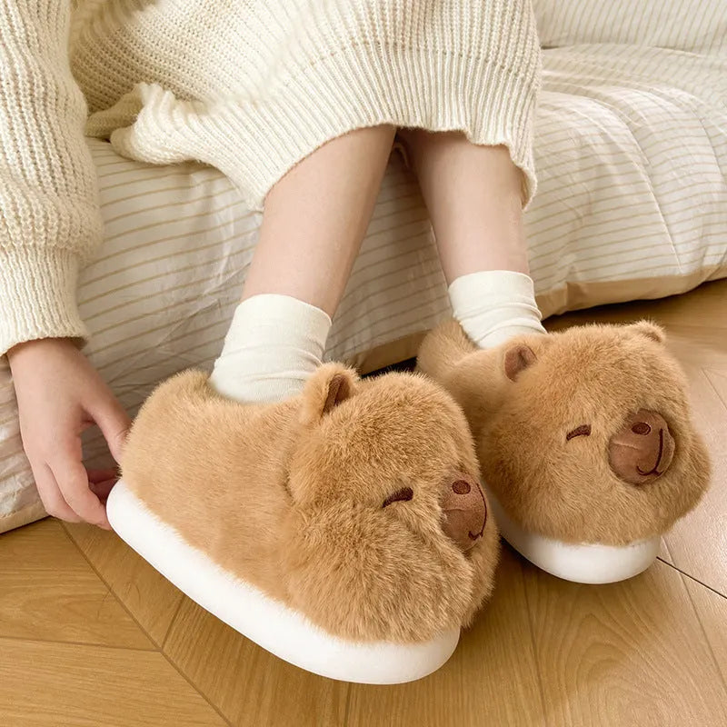 Light brown women's winter plush slippers with a cartoon pattern and artificial wool lining.