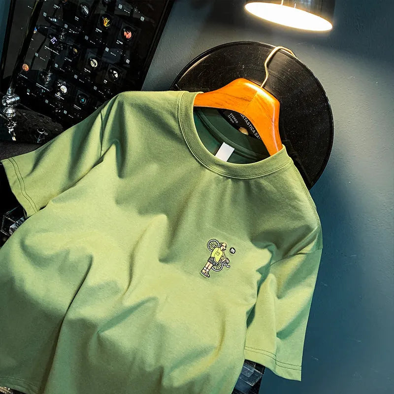 Green loose fit men's t-shirt with trendy printed design on short sleeves.