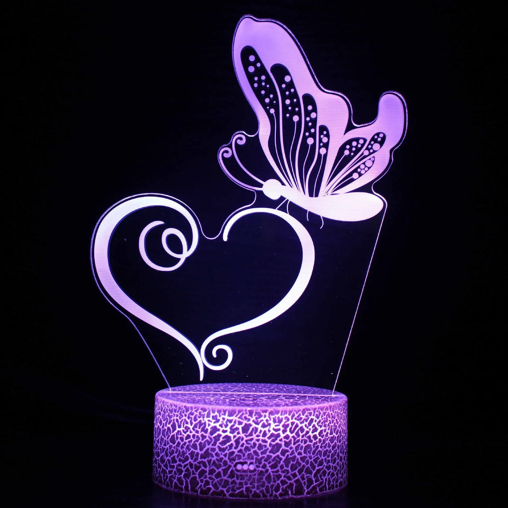 Small acrylic 3D touch-controlled USB table lamp with colourful crack-effect base on a desk.