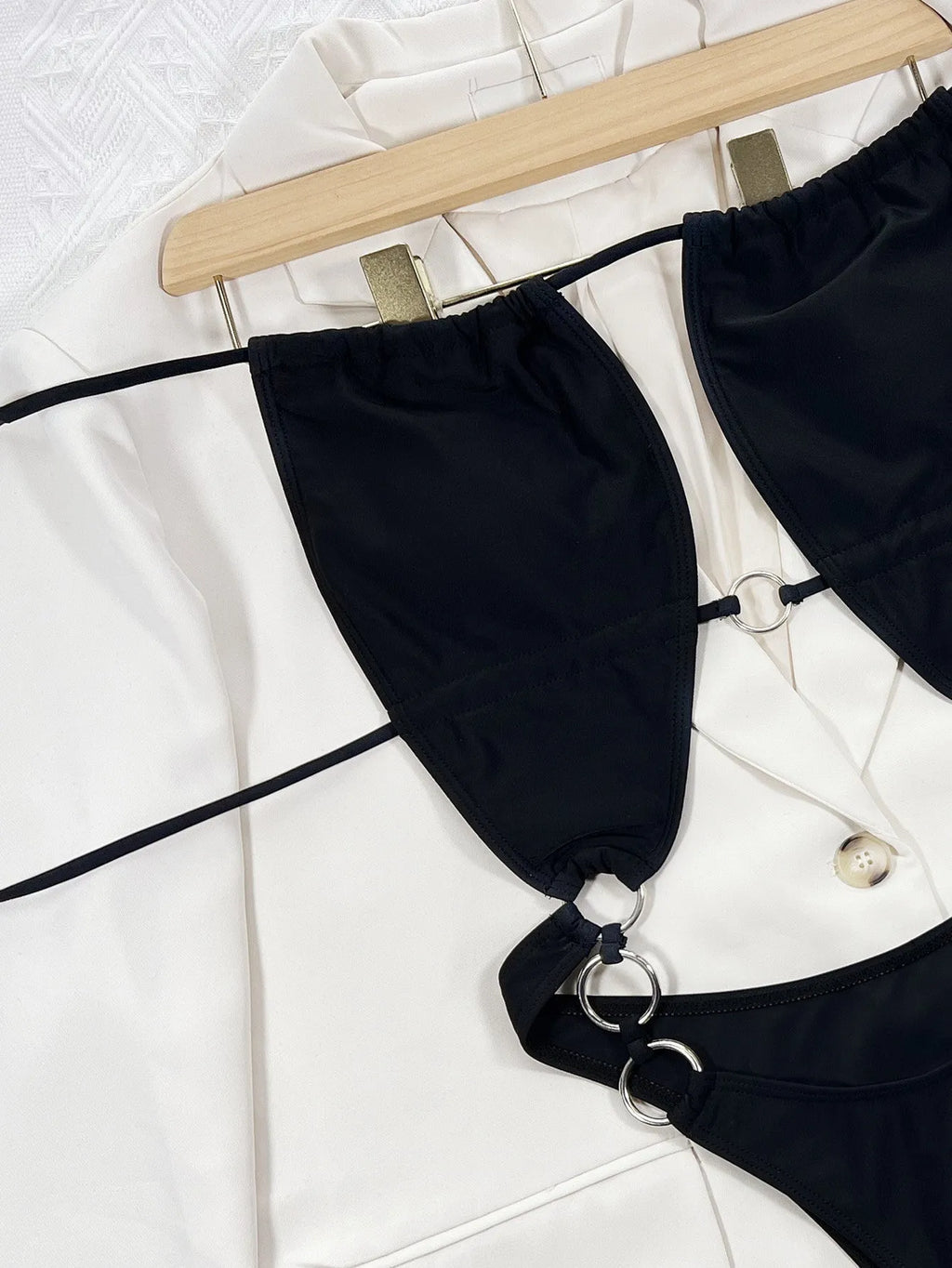 Black women's one-piece swimsuit with steel ring detail and sleeveless design