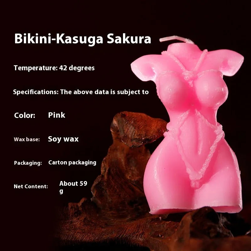 Soy wax low temperature massage candle in rose red, pink, or purple with bikini design.