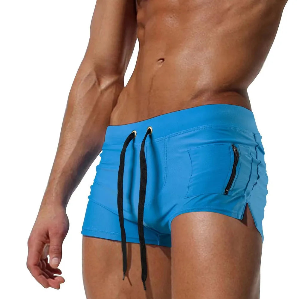 Men's black high waist swimming trunks with a front lace-up closure on a plain background.
