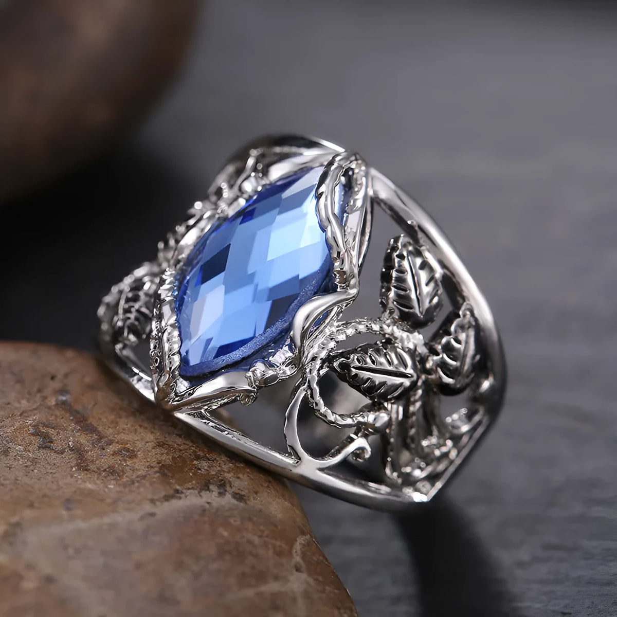 Blue horse eye-shaped crystal ring for women on a hand, showing geometric alloy design.