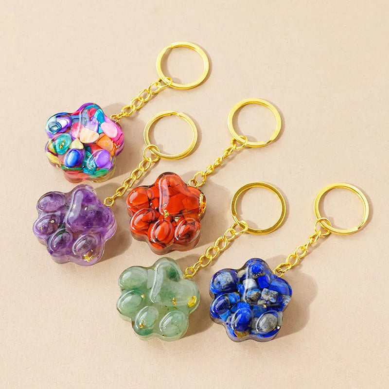 Small handcrafted crystal cat's paw shaped keychain pendant on a keyring.