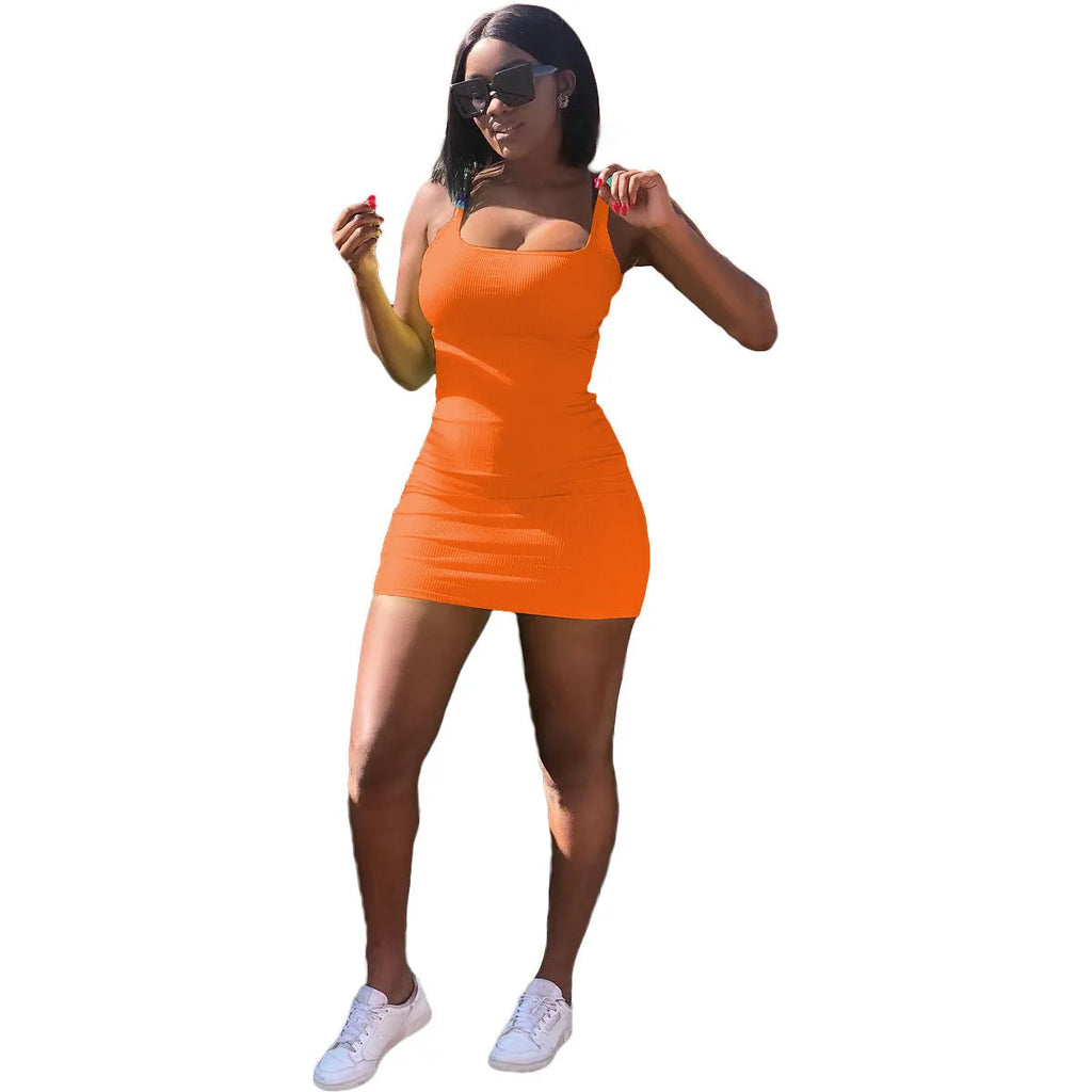 Woman wearing a slim fit casual dress with a big U-neck, sunken stripe straps, and princess sleeves.