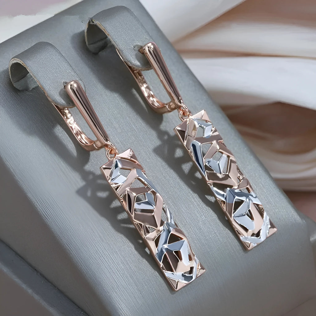 A pair of rectangular two-tone hollow stud earrings with an electroplated finish on a white background.