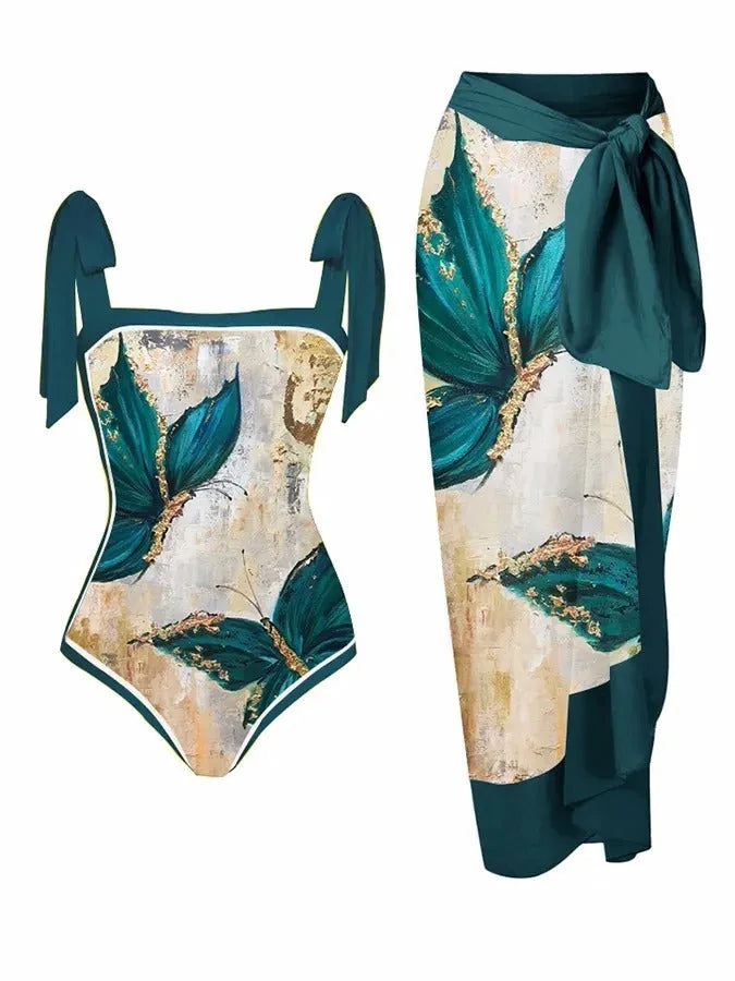 Women's floral print two-piece swimsuit with a sheer black chiffon hip skirt overlay.