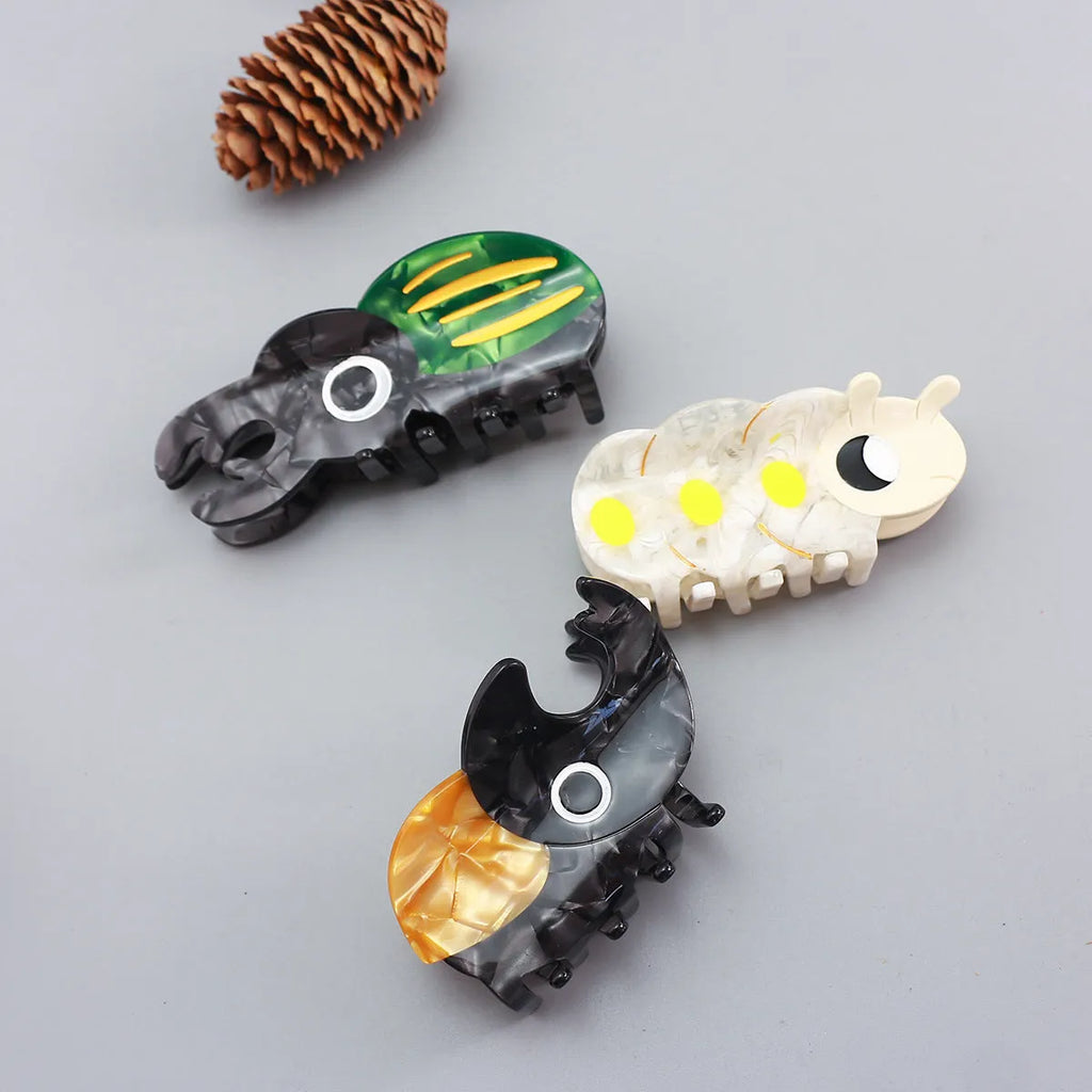 Handmade cellulose acetate beetle grip hair accessory with insect biology design