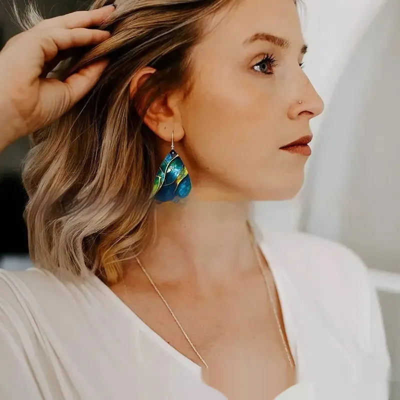 A pair of flat branch knot design drop earrings made from printed acrylic on a white background.