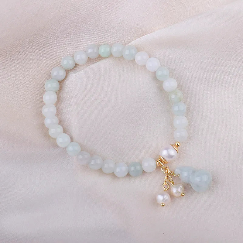 Women's jade bracelet with natural emerald jade insets and gourd design in Chinese style