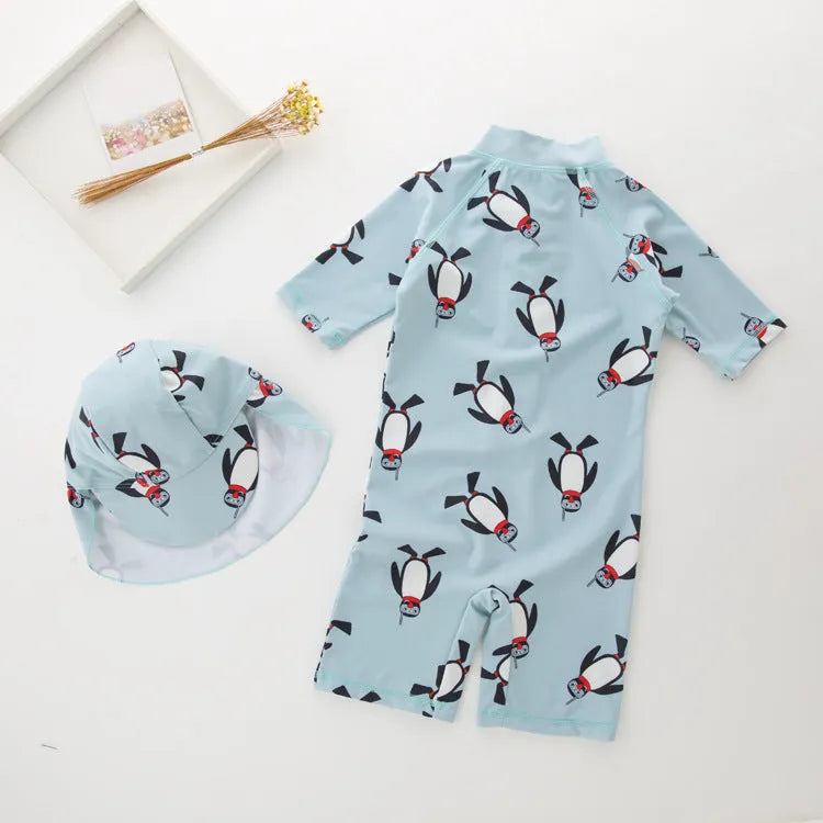 Boys' penguin print long sleeve swim shirt and matching swim cap set.