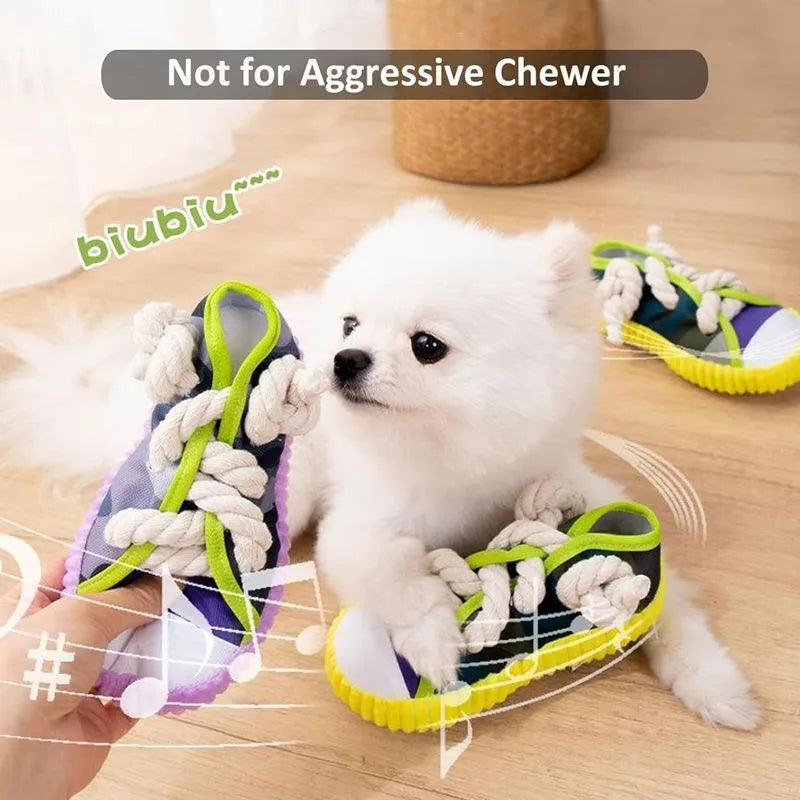 Realistic shoe-shaped dog toy in grey, purple, or yellow with laces, sole patterns, built-in squeaker and bell.
