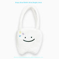 White plush tote bag with a cute teeth pattern, showing the shoulder strap and zipper closure