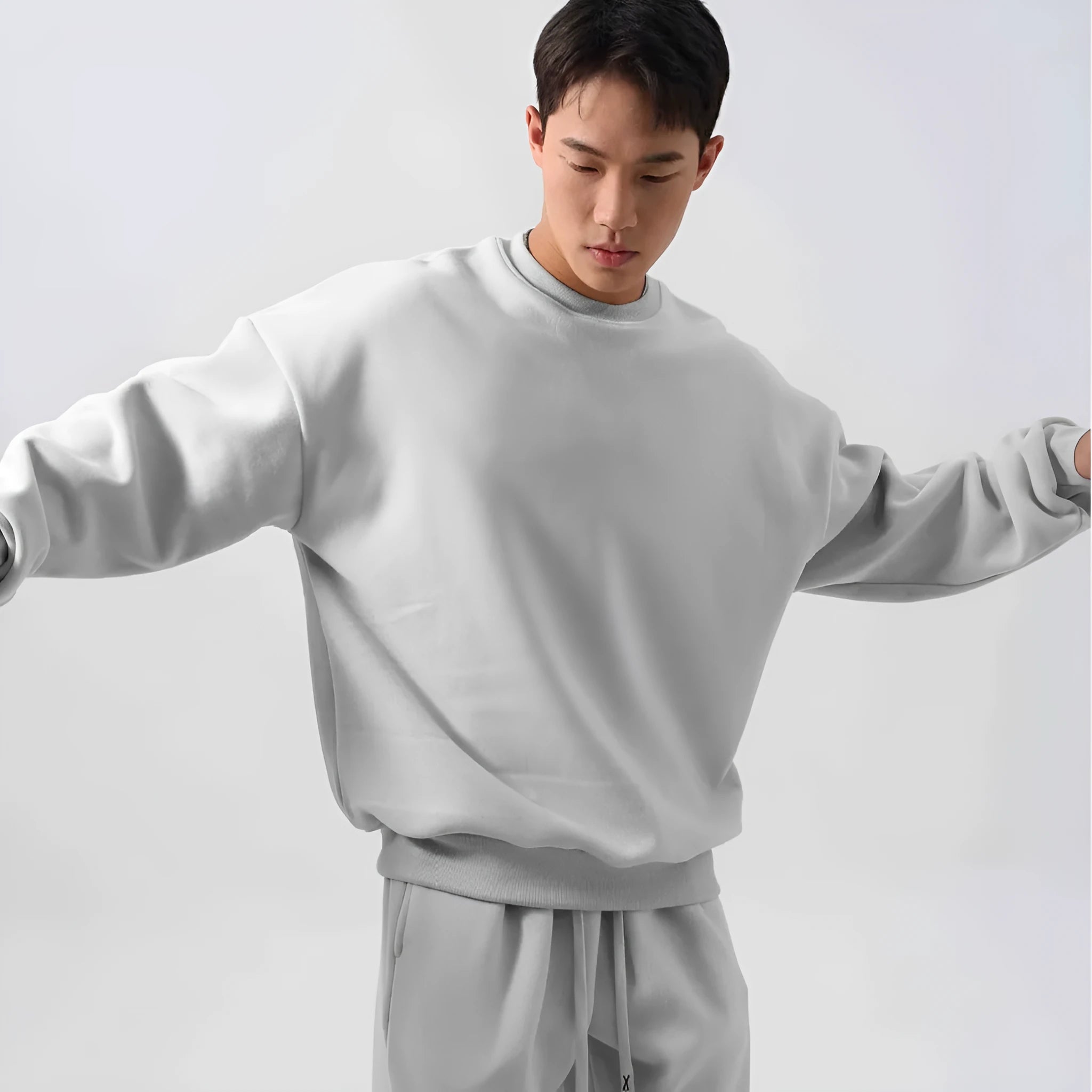 Men's black polar fleece sports suit with crew neck coat and padded trousers on a hanger