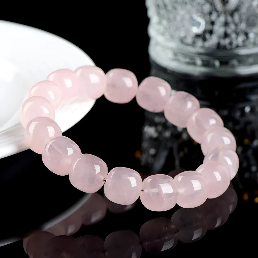 Pink bamboo crystal barrel bead bracelet with geometric design on wrist