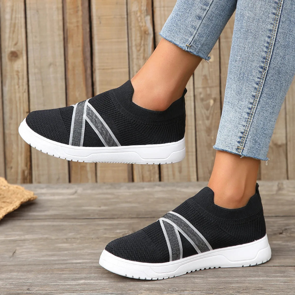 Black women's flyknit mesh casual shoes with flat rubber sole and round toe.