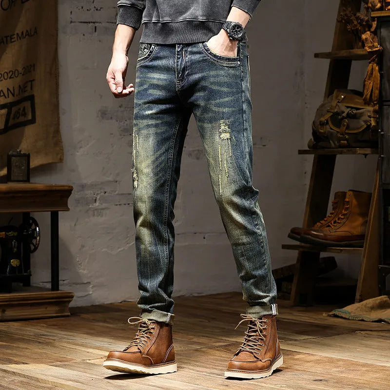 Men's skinny fit jeans in retro blue denim with a zip fly, shown laid flat.