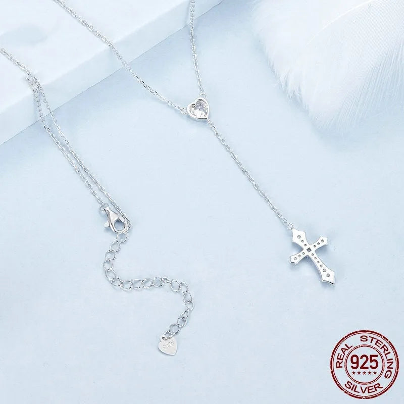 Silver V-neck Love Cross pendant on an O-ring chain necklace for women.