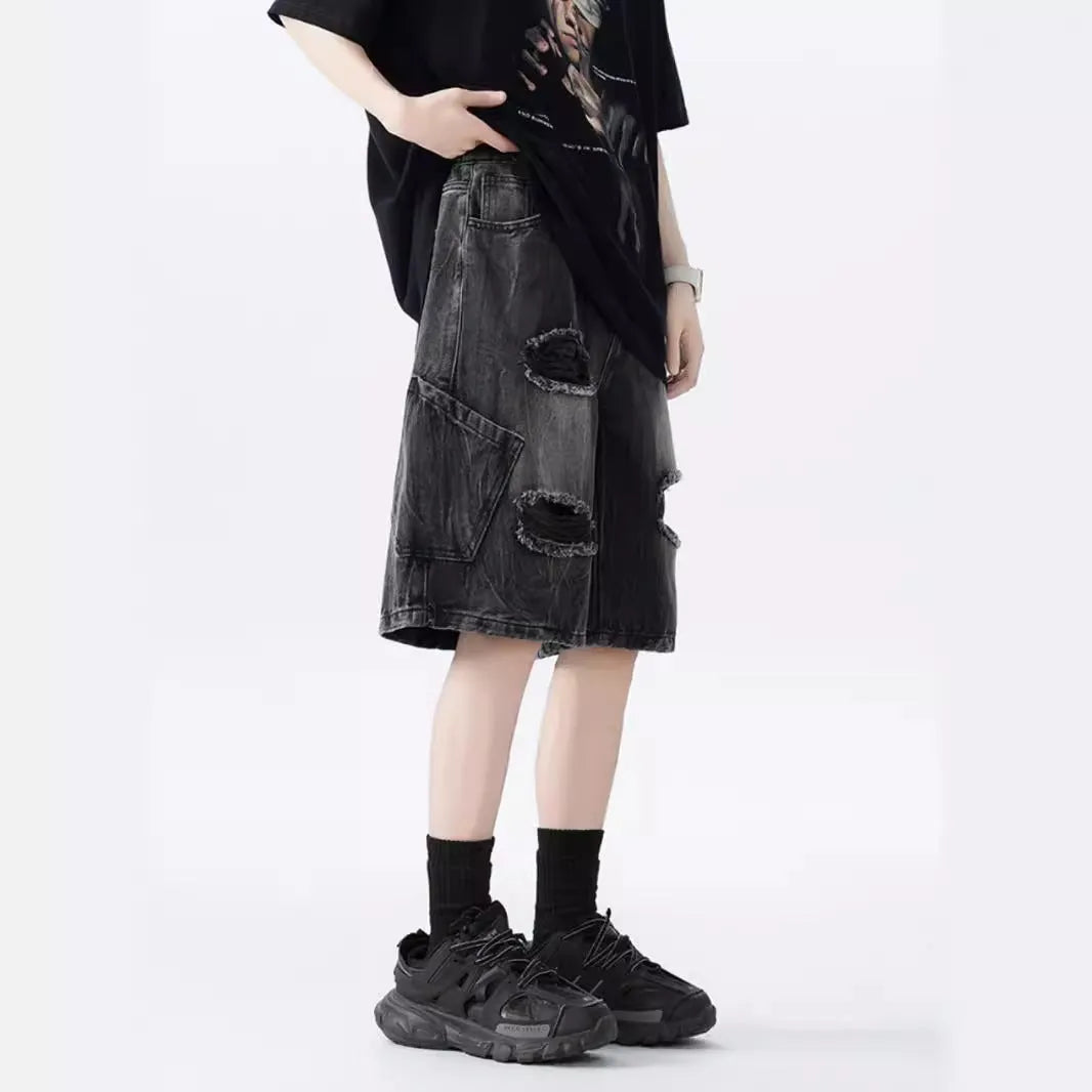 Washed blue denim shorts with ripped detailing on a hanger, showing loose retro fit