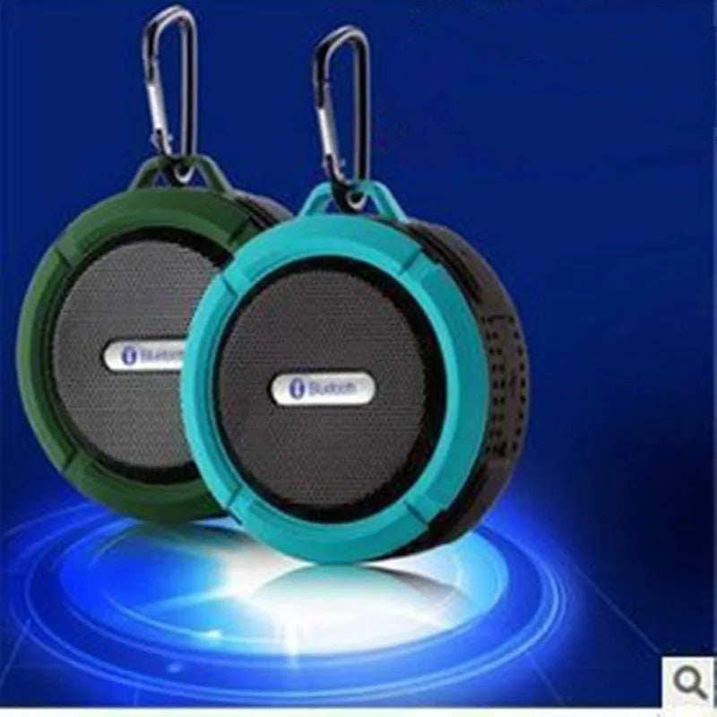 Colourful waterproof portable Bluetooth speaker with a black mounting buckle clip.