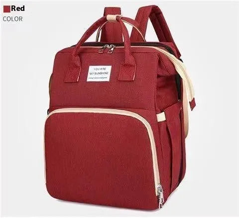 Folding mummy crib bag with curved shoulder strap showing USB interface and expandable storage design