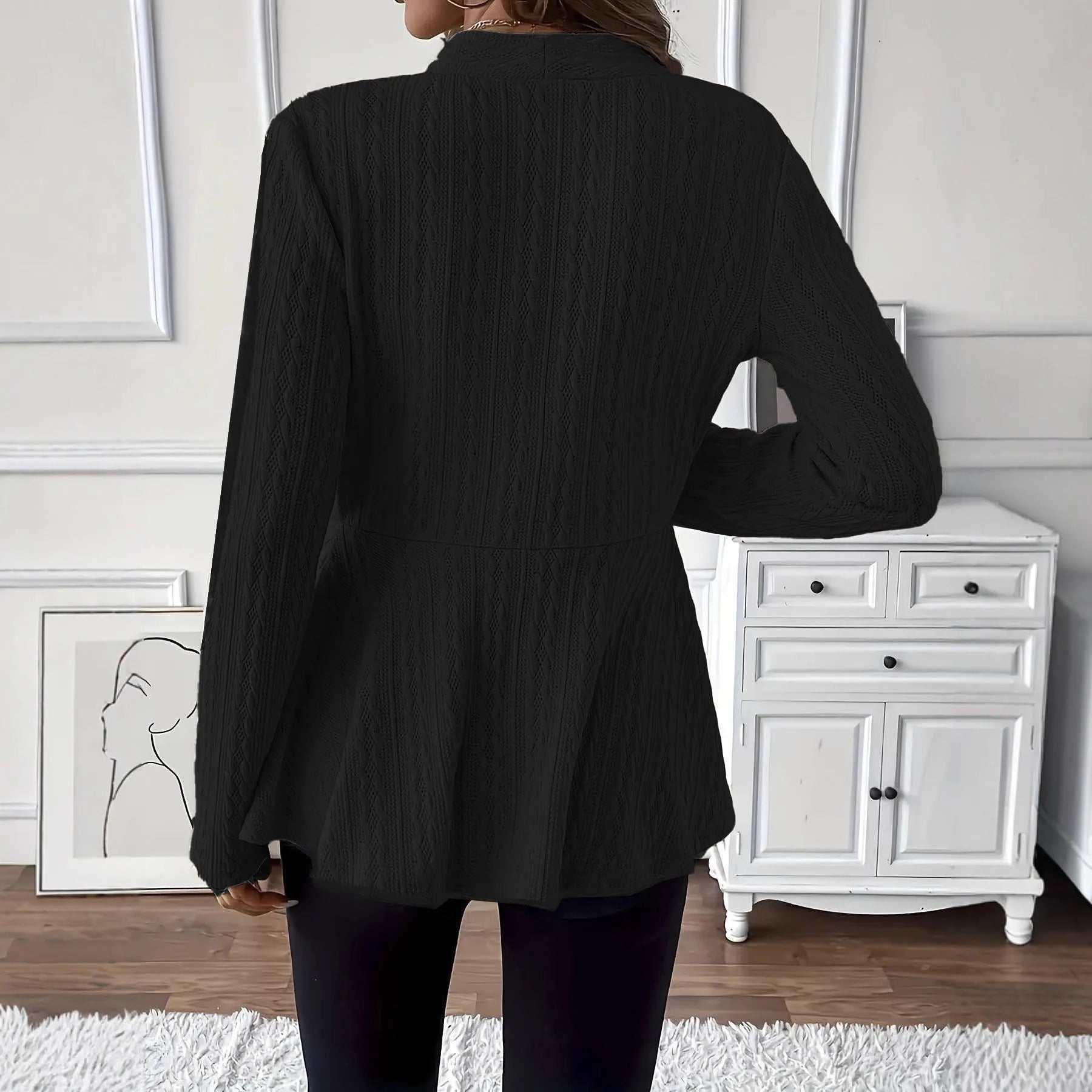 Women's apricot jacquard knit cardigan with one button front, shown on a model.