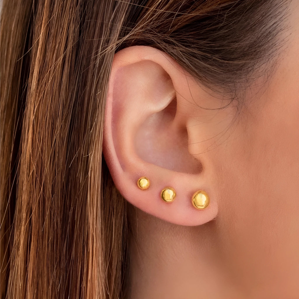 Gold and silver spherical ball stud earrings in 3mm, 4mm, 5mm, and 6mm sizes on a plain background.