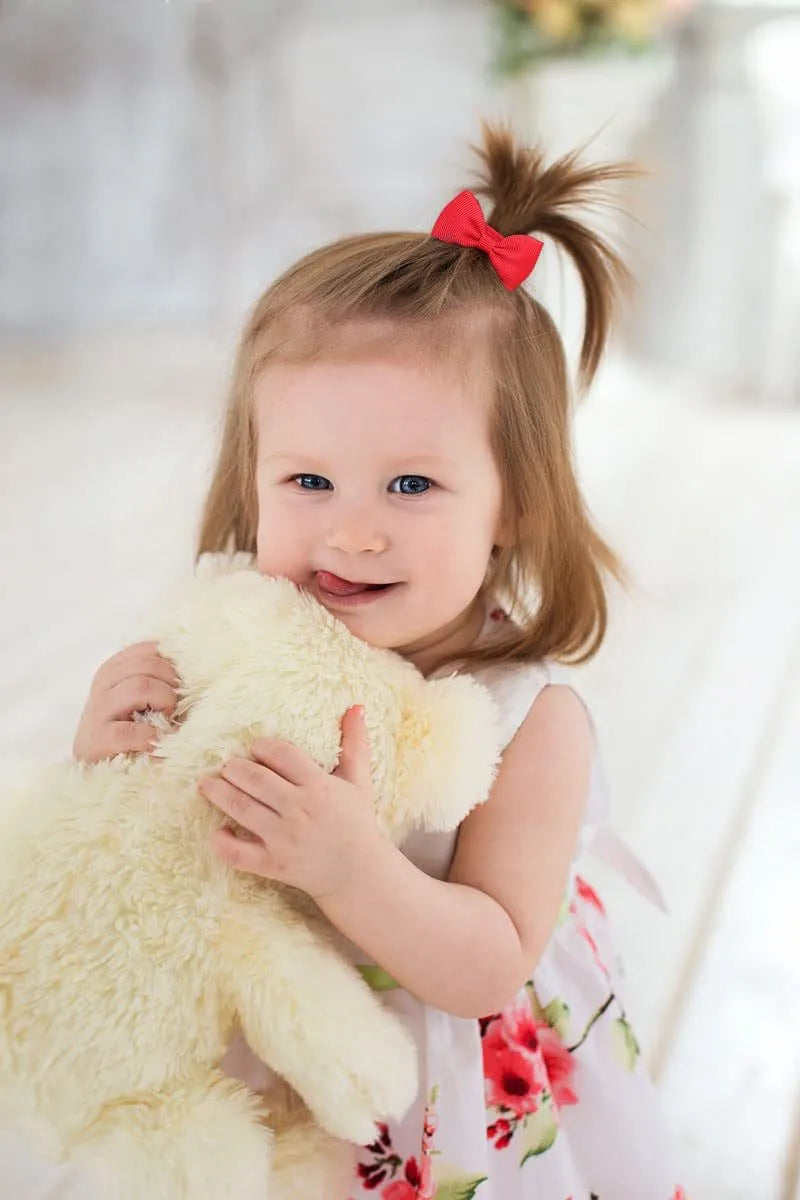 Multi-coloured baby hair ties with small grosgrain ribbon bows, soft elastic bands for infants and toddlers.