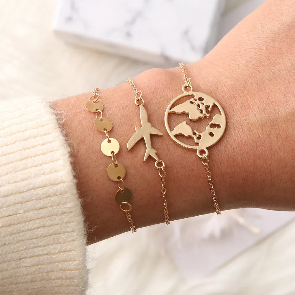 Three Bohemian-style bracelets with heart-shaped alloy charms featuring aircraft map designs